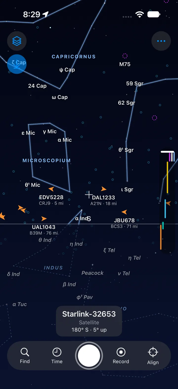 The Above sky view: constellation figures in blue, labelled stars, orange aircraft chevrons above the horizon line, and dimmed labels and dashed constellation lines below it.
